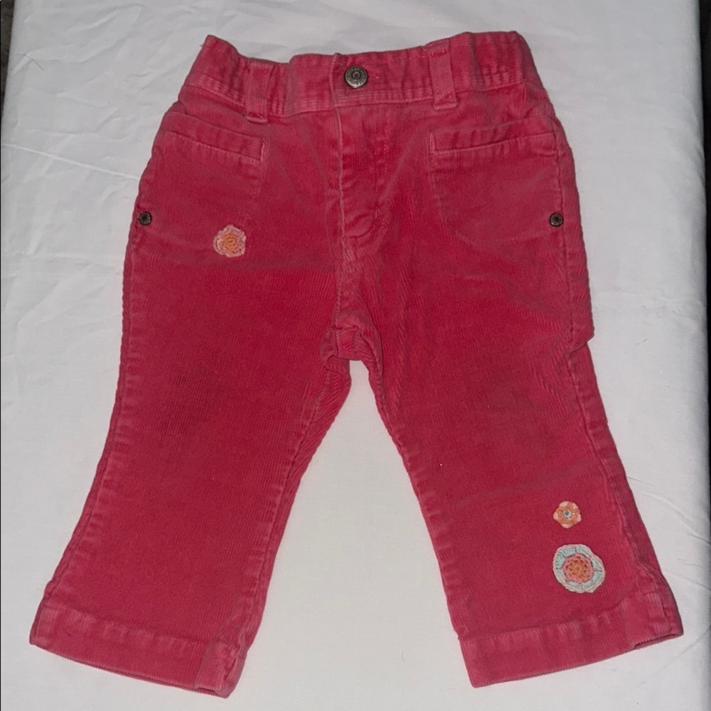 Pink corduroy jeans with flowers